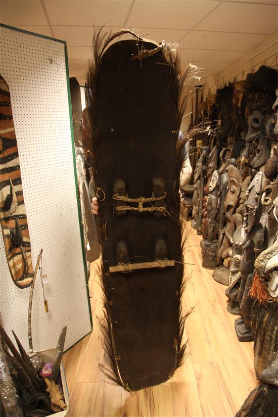 A Sepik River double mask shield, two garra masks, bullroarer etc (5)